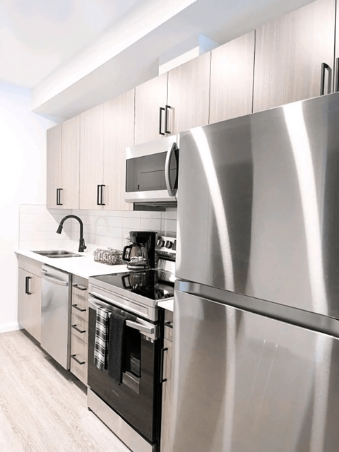 a kitchen with stainless steel appliances and a stainless steel refrigerator